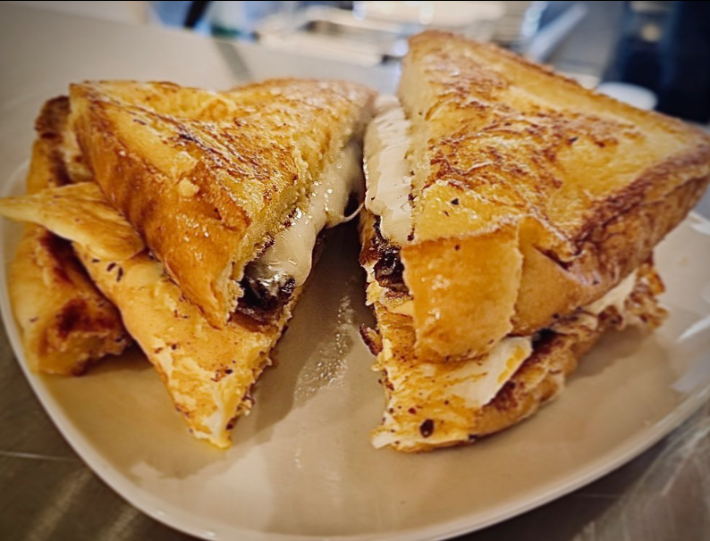 Stuffed French toast cut in half showing cream cheese and berry filling